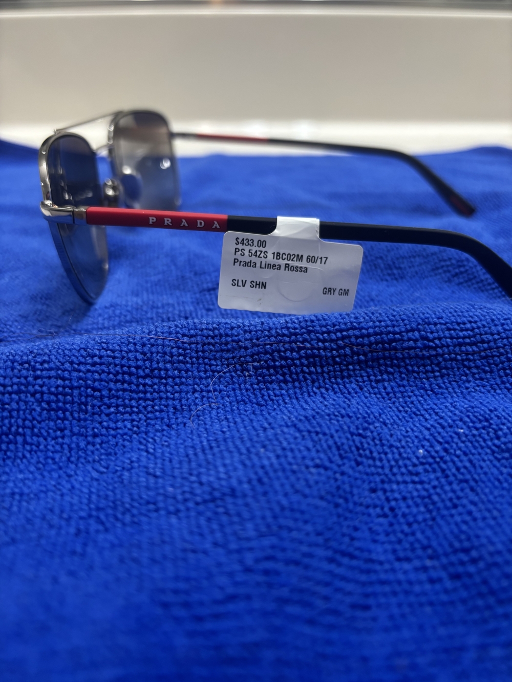 Prada Silver Frame Sunglasses with Red Temples and Gray Lenses
